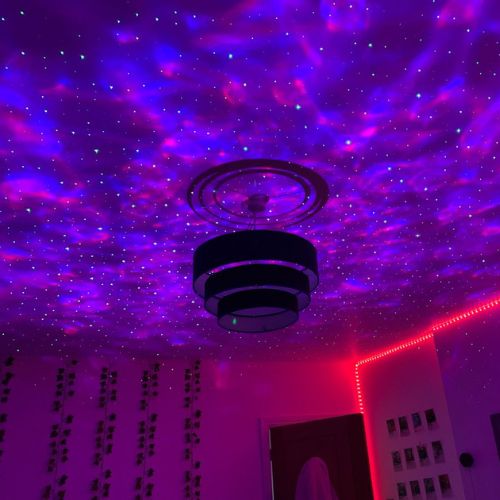 SpaceNaut galaxy projector lighting up a bedroom ceiling with stars